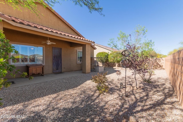 view of yard featuring ceiling fan, a fenced backyard, and a patio area