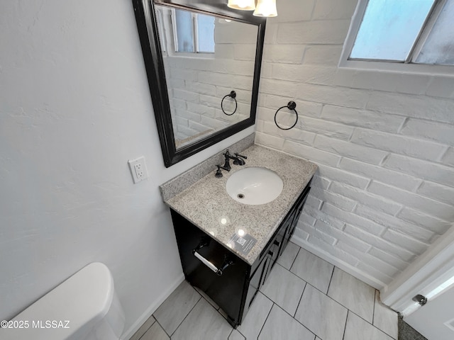 6760 S Calle Gavilan, Tucson, AZ 85746 - bathroom featuring a wealth of natural light, toilet, vanity, and baseboards