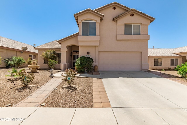 3825 W Perseus St, Tucson, AZ 85742 - mediterranean / spanish house featuring an attached garage, a tile roof, concrete driveway, and stucco siding