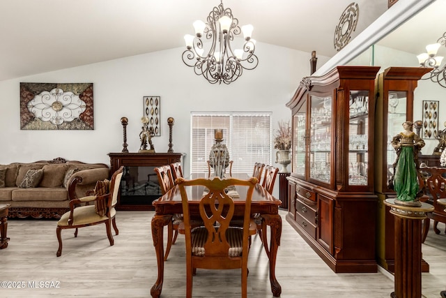 3825 W Perseus St, Tucson, AZ 85742 - dining room featuring vaulted ceiling, light wood-type flooring, and a notable chandelier