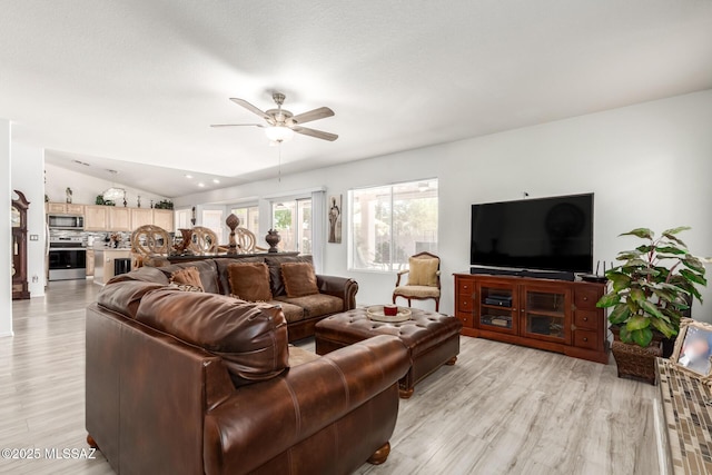 3825 W Perseus St, Tucson, AZ 85742 - living room featuring vaulted ceiling, light wood-style flooring, and ceiling fan