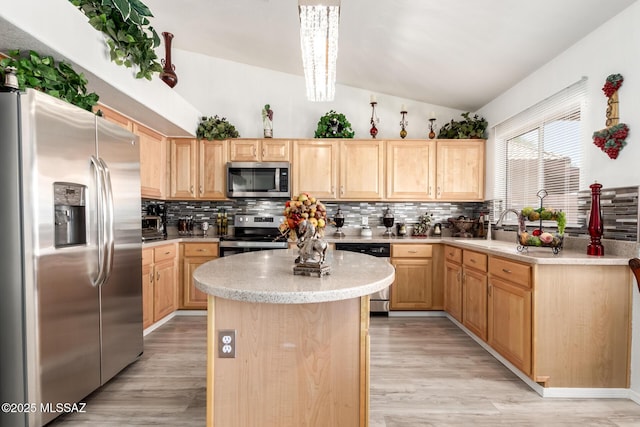 3825 W Perseus St, Tucson, AZ 85742 - kitchen with light brown cabinets, vaulted ceiling, tasteful backsplash, a sink, and appliances with stainless steel finishes