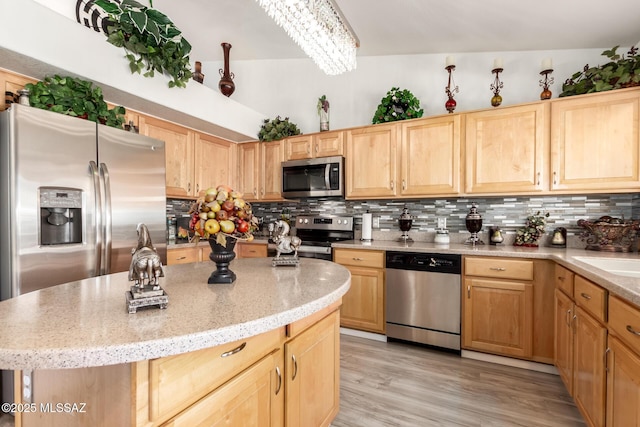 3825 W Perseus St, Tucson, AZ 85742 - kitchen with stainless steel appliances, light brown cabinetry, light stone counters, and tasteful backsplash