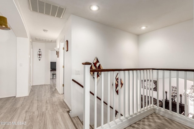 3825 W Perseus St, Tucson, AZ 85742 - corridor featuring wood finished floors, an upstairs landing, visible vents, and recessed lighting