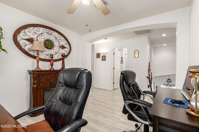 3825 W Perseus St, Tucson, AZ 85742 - home office with visible vents, arched walkways, light wood-style floors, and ceiling fan
