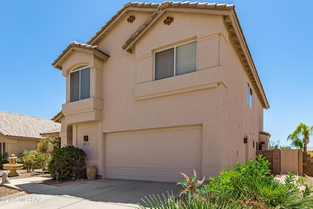 3825 W Perseus St, Tucson, AZ 85742 - view of front facade featuring stucco siding, a tile roof, fence, and a garage