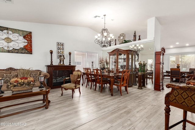 3825 W Perseus St, Tucson, AZ 85742 - dining room featuring lofted ceiling, visible vents, light wood-style floors, and a chandelier