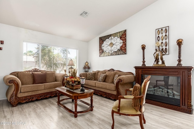 3825 W Perseus St, Tucson, AZ 85742 - living room featuring vaulted ceiling, light wood finished floors, and visible vents