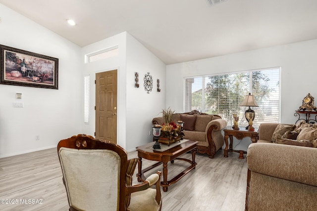 3825 W Perseus St, Tucson, AZ 85742 - living room featuring vaulted ceiling, baseboards, and light wood-style floors