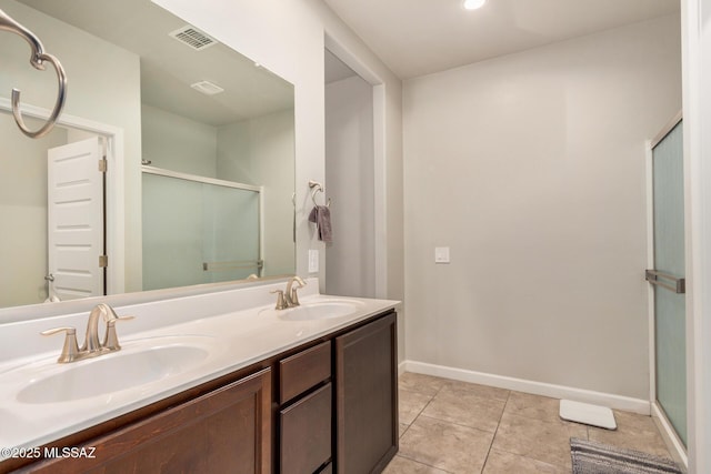 17949 S Whispering Glen Path, Sahuarita, AZ 85629 - full bathroom featuring a shower stall, baseboards, double vanity, and tile patterned flooring