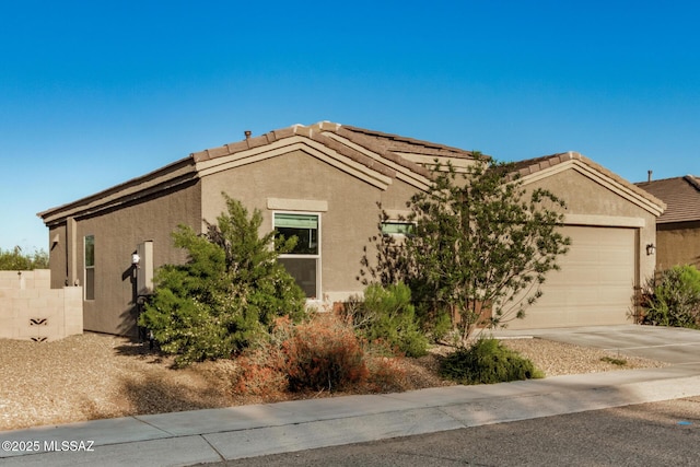 17949 S Whispering Glen Path, Sahuarita, AZ 85629 - view of front of property with a garage, concrete driveway, stucco siding, and a tiled roof