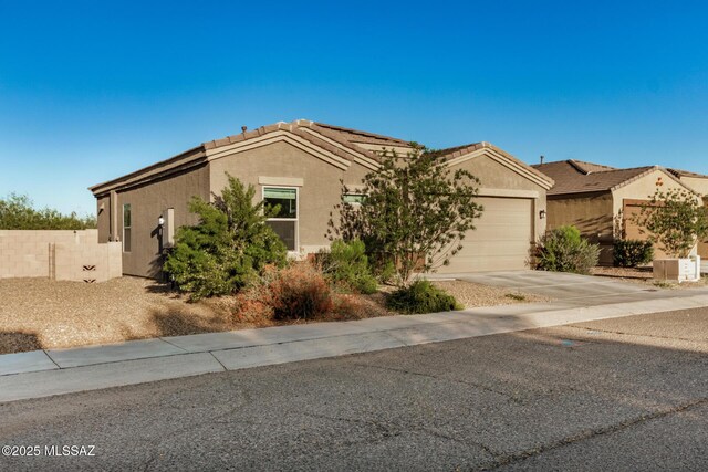 17949 S Whispering Glen Path, Sahuarita, AZ 85629 - view of front of property with an attached garage, concrete driveway, stucco siding, fence, and a tile roof