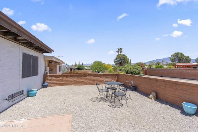 1376 S Desert Meadows Cir, Green Valley, AZ 85614 - view of patio featuring a mountain view, fence, and outdoor dining area