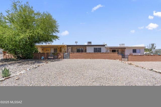 1376 S Desert Meadows Cir, Green Valley, AZ 85614 - single story home with a gate, a fenced front yard, and stucco siding