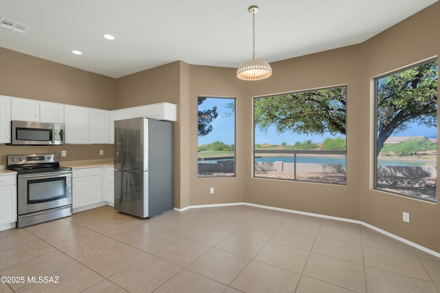 38876 S Serenity Ln, Tucson, AZ 85739 - kitchen with light tile patterned floors, stainless steel appliances, visible vents, and light countertops