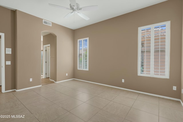 38876 S Serenity Ln, Tucson, AZ 85739 - unfurnished room with ceiling fan, visible vents, arched walkways, and light tile patterned floors