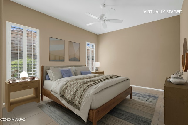 38876 S Serenity Ln, Tucson, AZ 85739 - bedroom featuring a ceiling fan, baseboards, and light tile patterned floors