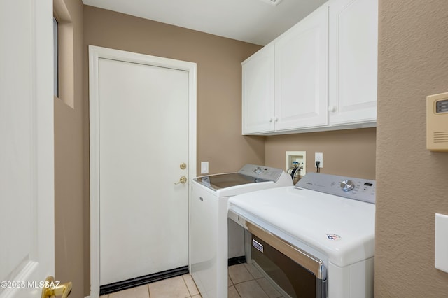 38876 S Serenity Ln, Tucson, AZ 85739 - clothes washing area with separate washer and dryer, light tile patterned floors, and cabinet space