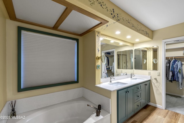 7361 E Riverbank Loop, Tucson, AZ 85715 - full bath with a walk in closet, a sink, and wood finished floors