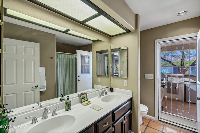 7361 E Riverbank Loop, Tucson, AZ 85715 - full bath with toilet, tile patterned flooring, a sink, and double vanity