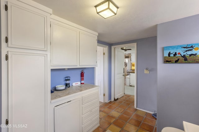 280 W Oak Hills Dr, Oracle, AZ 85623 - kitchen featuring light countertops, white cabinets, tile patterned flooring, and baseboards