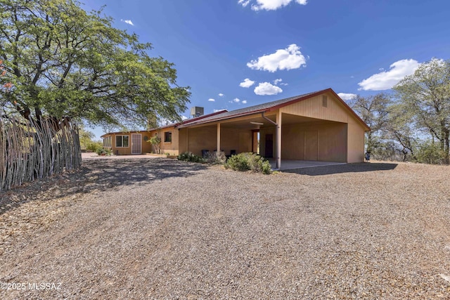 280 W Oak Hills Dr, Oracle, AZ 85623 - view of front of home with gravel driveway, a chimney, and a carport