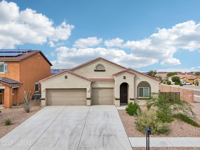 mediterranean / spanish-style home with cooling unit, an attached garage, stucco siding, and driveway
