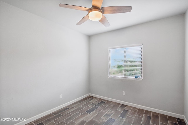 empty room featuring baseboards, ceiling fan, and dark wood finished floors
