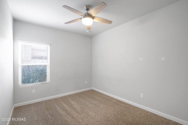 carpeted spare room with baseboards and a ceiling fan