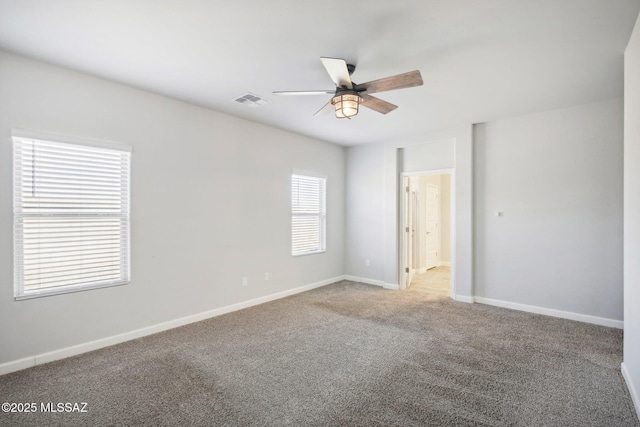 unfurnished room featuring ceiling fan, baseboards, carpet flooring, and visible vents
