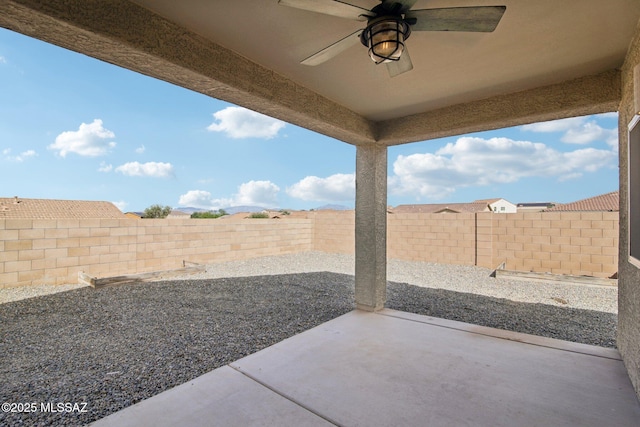 view of patio with a fenced backyard and ceiling fan