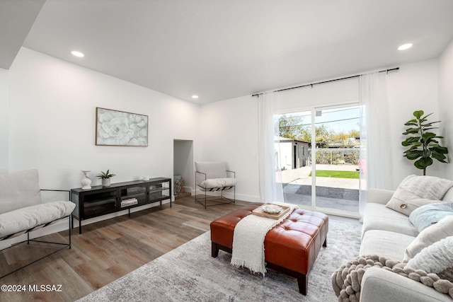living room with baseboards, wood finished floors, and recessed lighting