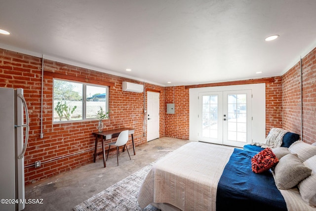 bedroom with brick wall, freestanding refrigerator, access to outside, and unfinished concrete flooring