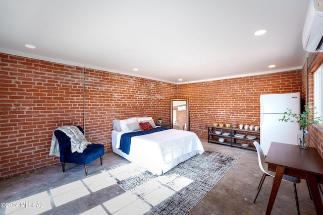 bedroom featuring concrete flooring, recessed lighting, a wall mounted AC, brick wall, and freestanding refrigerator