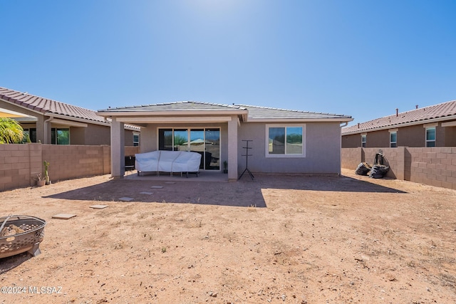 21372 E Charmaine Rd, Red Rock, AZ 85145 - back of house with a patio, an outdoor fire pit, a fenced backyard, and stucco siding