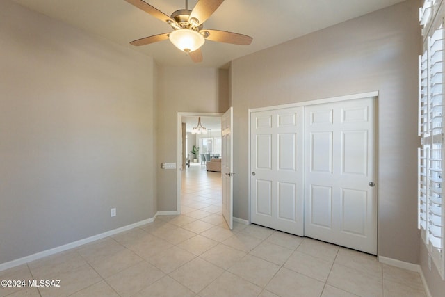 5152 W Heritage Gateway Pl, Marana, AZ 85658 - unfurnished bedroom with ceiling fan, baseboards, a closet, and light tile patterned floors