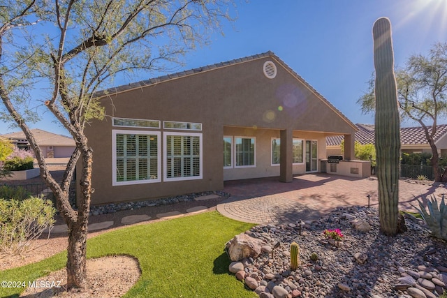 5152 W Heritage Gateway Pl, Marana, AZ 85658 - rear view of house featuring stucco siding, fence, a patio area, and exterior kitchen