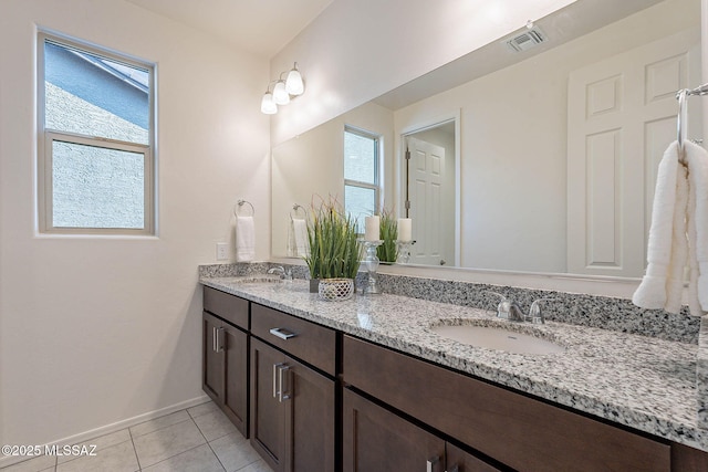 10965 N Cormac Ave, Tucson, AZ 85742 - full bath featuring double vanity, tile patterned floors, and baseboards
