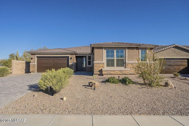 10965 N Cormac Ave, Tucson, AZ 85742 - single story home featuring stone siding, stucco siding, a garage, driveway, and a tiled roof