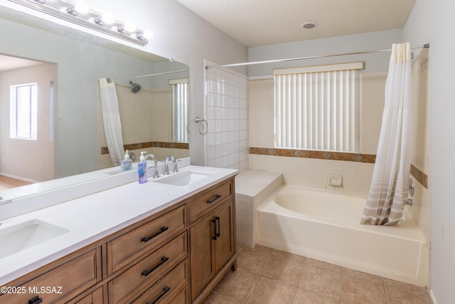 full bathroom with tile patterned flooring, curtained shower, a washtub, and a sink