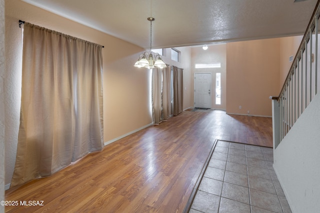 entryway featuring an inviting chandelier and light wood-style floors