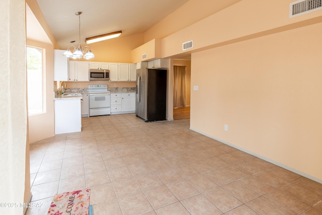 kitchen featuring appliances with stainless steel finishes, a chandelier, visible vents, and light tile patterned floors