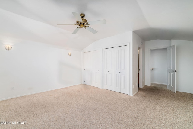 3748 N Sabino Ridge Pl, Tucson, AZ 85750 - unfurnished bedroom with vaulted ceiling, multiple closets, carpet flooring, baseboards, and ceiling fan