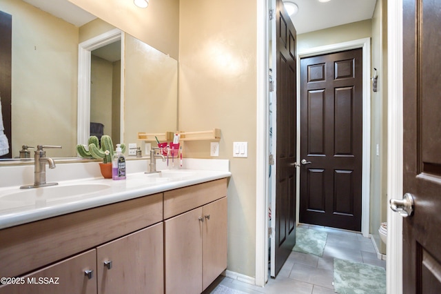 6515 E Vuelta Tierra Blanca, Tucson, AZ 85756 - bathroom featuring double vanity, toilet, baseboards, and tile patterned flooring