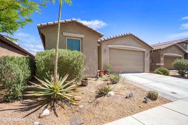 6515 E Vuelta Tierra Blanca, Tucson, AZ 85756 - view of front of house with an attached garage, stucco siding, driveway, and a tile roof