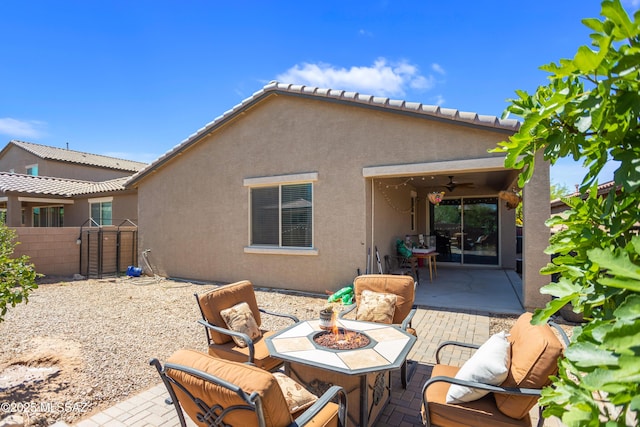 6515 E Vuelta Tierra Blanca, Tucson, AZ 85756 - rear view of property featuring stucco siding, a fire pit, a patio area, and a ceiling fan