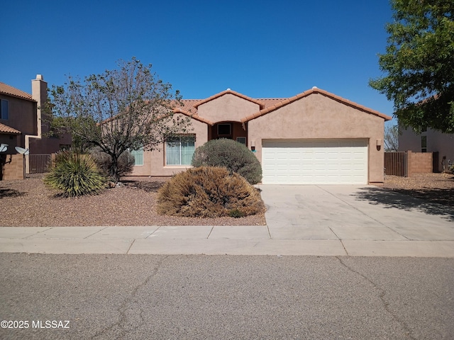 ranch-style house with a tiled roof, concrete driveway, fence, an attached garage, and stucco siding