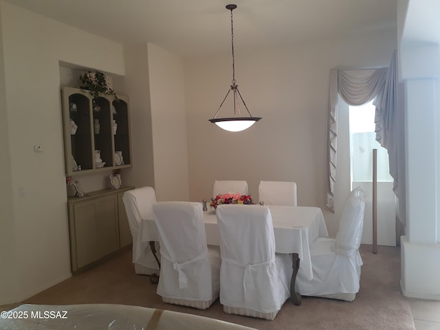 dining space with light colored carpet