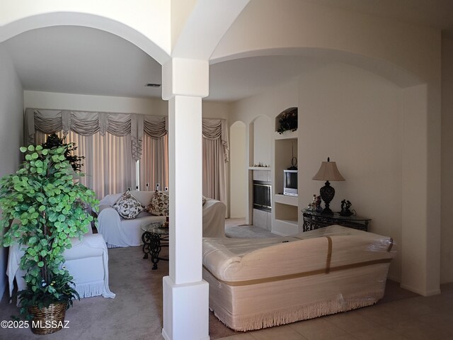 bedroom with arched walkways and visible vents