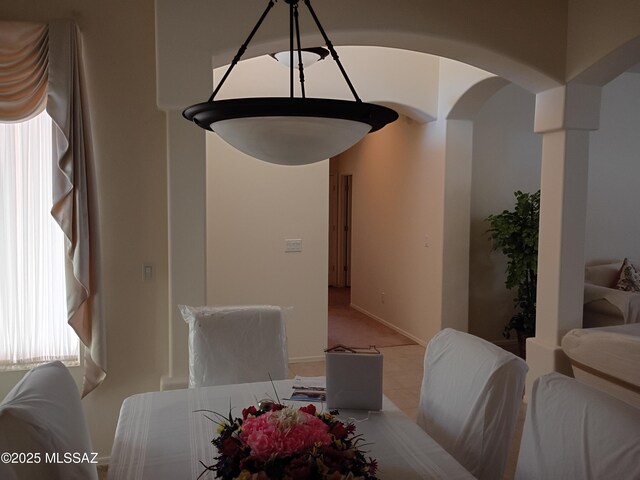 dining room featuring arched walkways